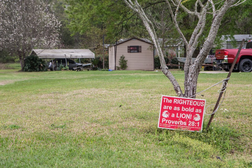 A yard sign with a bible scripture is posted in a yard in Kountze, TX Friday March 18, 2016.