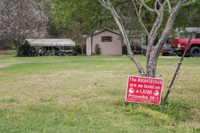 A yard sign with a bible scripture is posted in a yard in Kountze, TX Friday March 18, 2016.